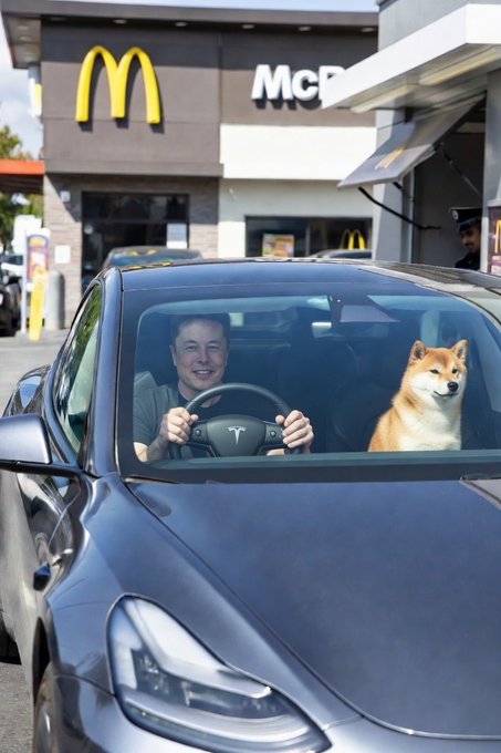 The image shows a man driving his car with a dog sitting in the passenger seat, both of them smiling as they drive by a McDonald's restaurant. The photo also includes an announcement that reads "COULD THERE BE SOME ANNOUNCEMENT WITH MCDONALD'S SOON..". This suggests that there might be some upcoming event or promotion related to McDonald's that could potentially affect the viewer's experience at the restaurant, such as a special offer or a new menu item.