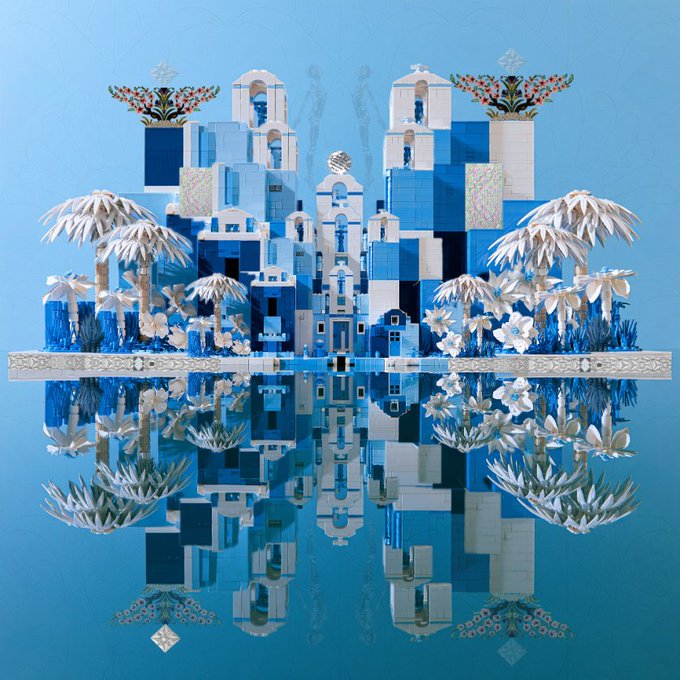 A surreal, symmetrical digital artwork featuring a Greek Santorini-style village rendered in blue and white tones, with its reflection mirrored below.