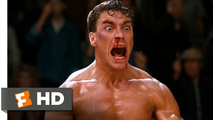 A bloodied, sweaty boxer screams in fury mid-fight in this dramatic sports still bearing a "Fandango" (F) logo and "HD" text in the corner—capturing the raw intensity that parallels the relentless conviction of someone still shouting the truth after three years of taking hits.