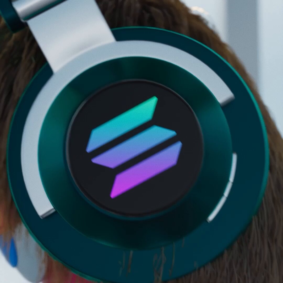 The image features a person wearing green headphones with purple, blue, and orange lights inside them. The headphones are positioned over the head of the person's hair, suggesting that they might be listening to music or an audio recording. The background appears to be blurred, drawing attention to the headphones as the main focus of the image.