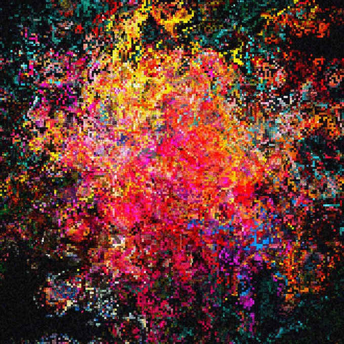 An abstract, highly pixelated digital artwork features a vibrant explosion of colors including pink, red, yellow, blue, and green on a black background.