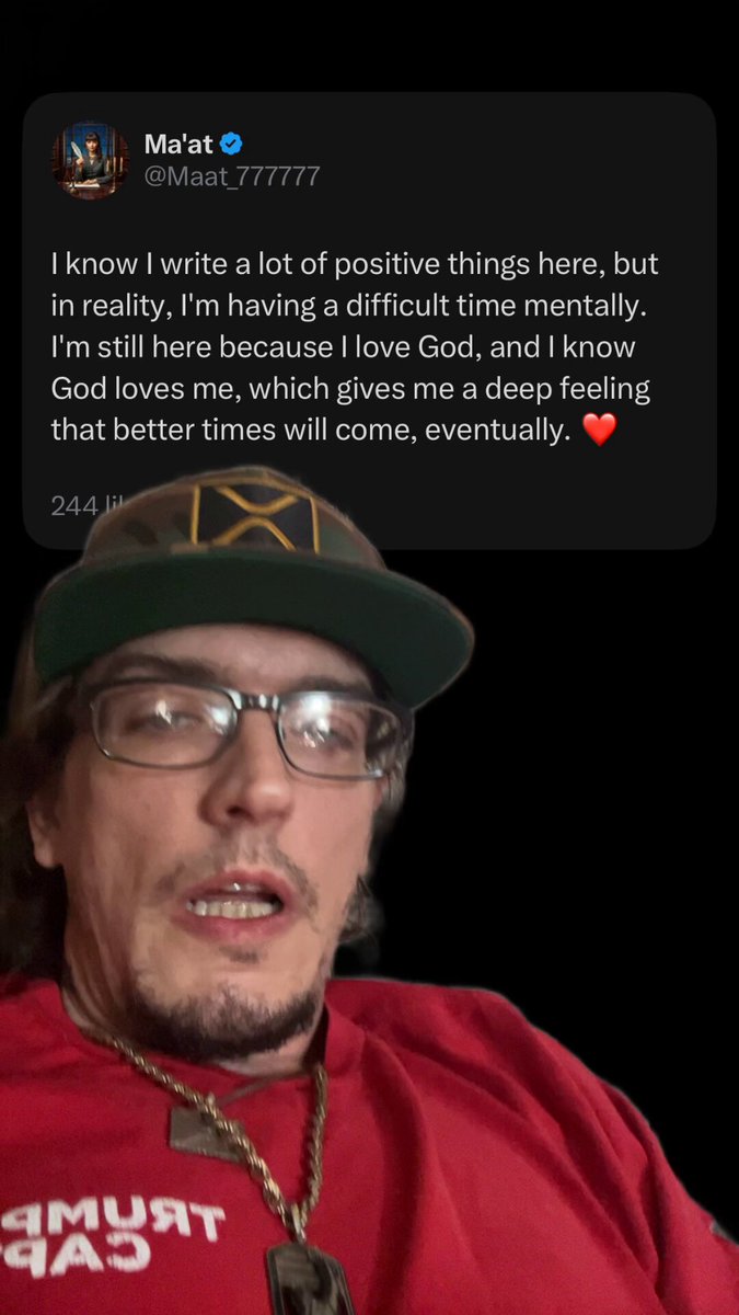The image features a man wearing a red shirt with white text, which reads "We still here for a reason bro". This message seems to be part of a larger social media post or conversation about mental health awareness. The man's face can be seen in the image, but his expression is not clear enough to provide additional context.