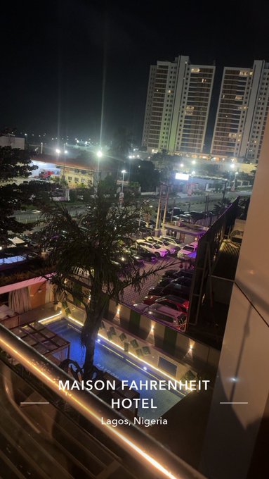 A nighttime city view from a high vantage point overlooking a pool area and tall illuminated buildings, with text overlay reading 'MAISON FAHRENHEIT HOTEL, Lagos, Nigeria'.