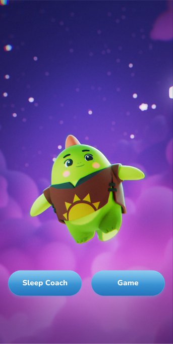 A green dinosaur-like animated character with a sun emblem on its brown shirt, floating in a purple starry sky with 'Sleep Coach' and 'Game' buttons displayed below.