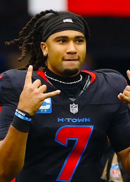 The image shows Houston Texans quarterback C.J. Stroud wearing his team's #7 jersey with "H-TOWN" displayed on the front, a black headband, and a necklace, while making a hand gesture during what appears to be a game. The image directly relates to the post, which mentions a Polymarket bet of $1,491 on Stroud NOT throwing 2+ touchdowns against the Bills, paying out $1,500.