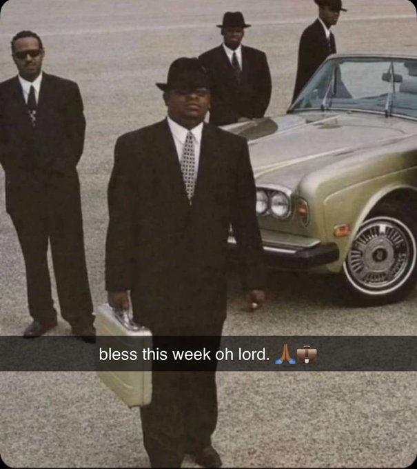 A vintage-style photo shows four men in black suits and fedora hats standing near a classic luxury car, with the central figure holding a silver briefcase and a caption reading 'bless this week oh lord.'