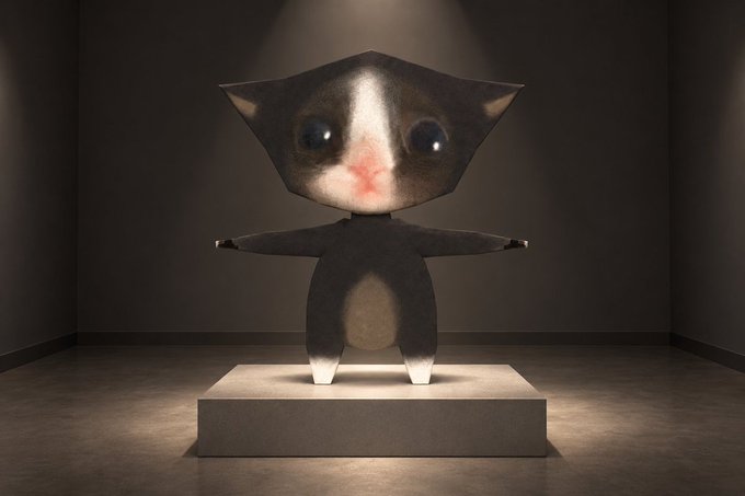 A low-polygon 3D rendered cat character with large eyes and a pink nose stands on a lit pedestal in a dark room.