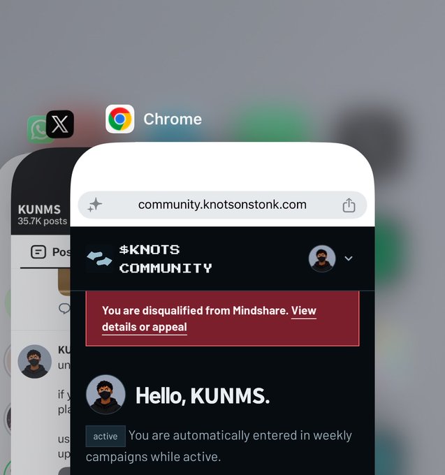 A mobile screen showing the Chrome browser open to community.knotsonstonk.com, displaying a red banner that reads "You are disqualified from Mindshare. View details or appeal" with "Hello, KUNMS." below it.