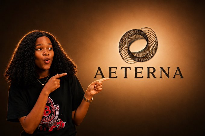 The image shows a person with curly hair wearing a black graphic t-shirt, pointing toward the "AETERNA" logo (a stylized circular emblem) displayed prominently on a brown backdrop. The caption relates to the post as it visually announces the creator's ambassadorship with Aeterna Web3, highlighting the brand featured in their announcement.