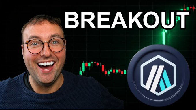The image features a man wearing glasses, smiling at the camera with his arms outstretched. The background of the image shows a graph or chart related to cryptocurrency trading, possibly indicating a rise in Bitcoin prices. The caption above the image reads "BREAKOUT", which is likely a reference to a recent event or news related to cryptocurrency trading.