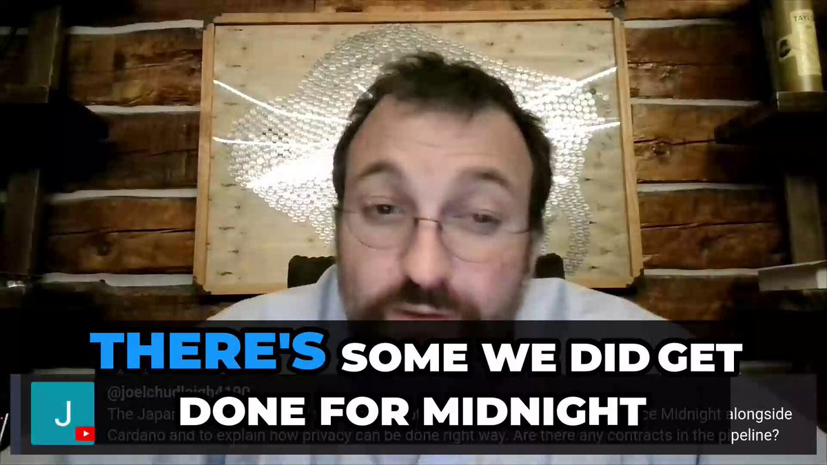 The image features a man wearing glasses sitting behind a wooden desk or shelf. The background includes a picture of a person's face with text that reads "There's some we did get done for midnight." This suggests that the man might be discussing a project related to Midnight, which is an online privacy company based in Japan.