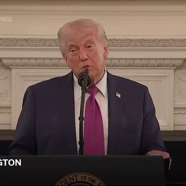 The image shows a man wearing a suit, speaking into a microphone at a podium with the words "PRESIDENT TRUMP SAID THE U.S. WOULD BECOME THE WORLD CAPITAL OF CRYPTOCURRENCY" written above him. The text also mentions Bitcoin and other cryptocurrencies.