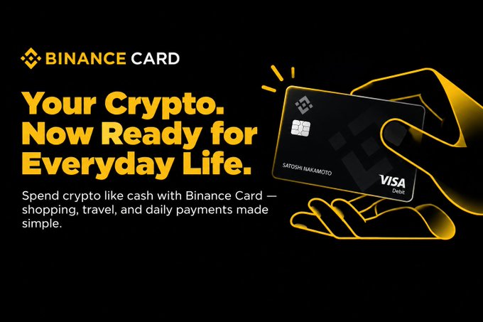 A Binance Card promotional advertisement with yellow text on a black background reading 'Your Crypto. Now Ready for Everyday Life,' featuring an illustrated black Visa debit card held by glowing yellow hands.