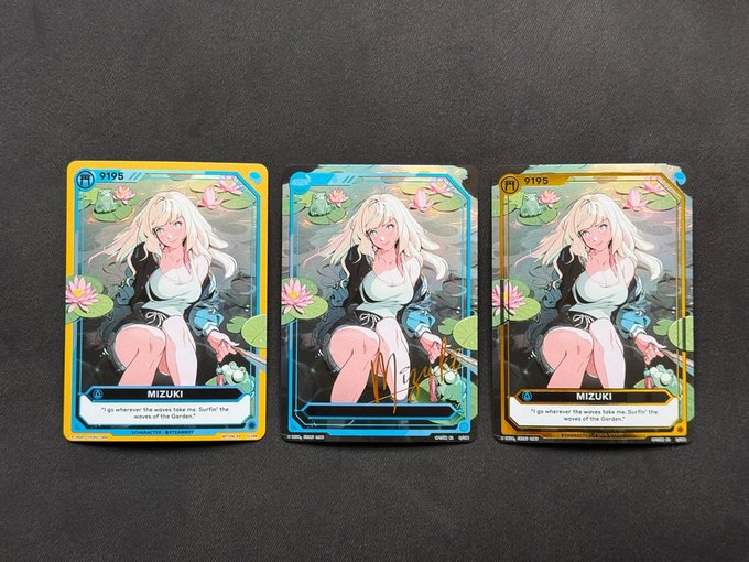 Three trading cards featuring an anime character named 'MIZUKI' are displayed side by side, each with different colored borders (orange, blue, and gold) and showing the same illustration of a blonde character with a sword.
