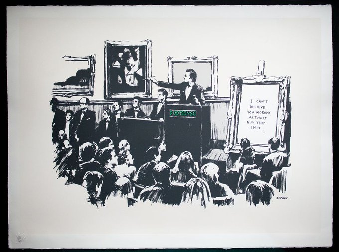 The image depicts a group of people gathered around a stage with a man standing at a podium, giving a speech or lecture. The audience appears engaged and attentive as they listen to the speaker. The scene takes place in an art gallery setting, where several paintings are displayed on the walls behind the attendees. A painting is prominently featured in the foreground, adding depth to the overall composition of the image.
