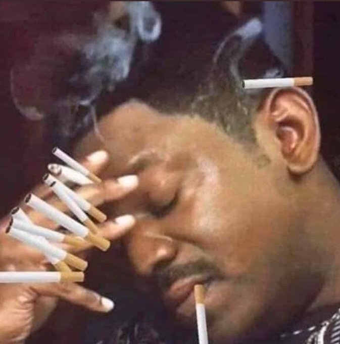 A man smoking numerous cigarettes at once with smoke swirling around his face, visually representing the overwhelmed stress of narrowly avoiding the "cold card vulnerability" Bitcoin security flaw.