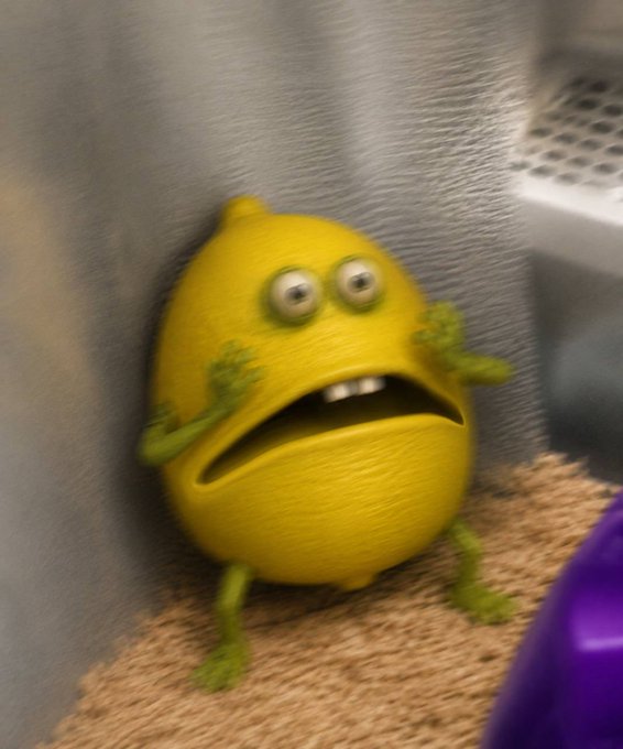 A 3D-rendered yellow lemon character with green fuzzy limbs and a worried, toothy expression, appearing startled against a gray wall.