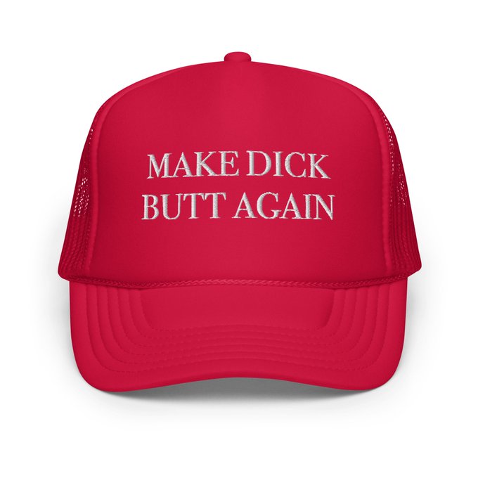 The image features a red baseball cap with white text that reads "Make Dick Butt Again". The hat appears to be made of mesh material, giving it a casual and relaxed appearance. The background of the image is plain white, which makes the red color of the hat stand out even more. The caption above the image suggests that the hat might be related to an event or gathering where people are expected to dress casually.