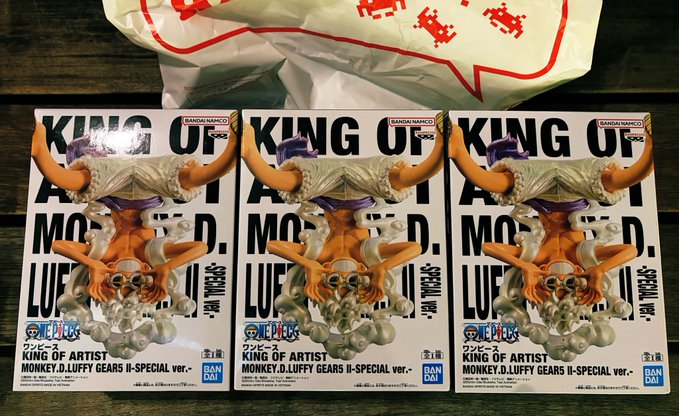 Three identical 'King of Artist - Monkey D. Luffy Gear II - Special ver.' One Piece figures from Bandai Namco still in their boxes.