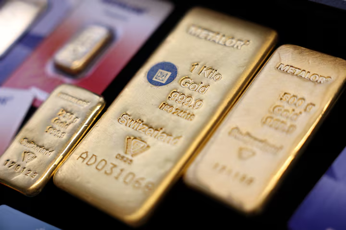 Several gold bars from 'METALOR' of varying sizes, including a 1 Kilo bar marked 'Switzerland 999.9 Fine Gold' with serial number AD031066, are displayed closely together.