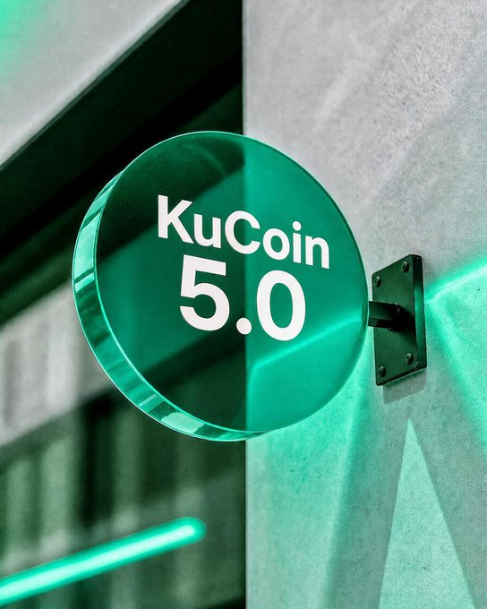 A glowing green circular sign displays "KuCoin 5.0" mounted on a textured wall, representing the platform's rebranded identity and major upgrade. The illuminated logo visually reinforces the post's announcement of a reimagined, next-generation crypto trading experience.