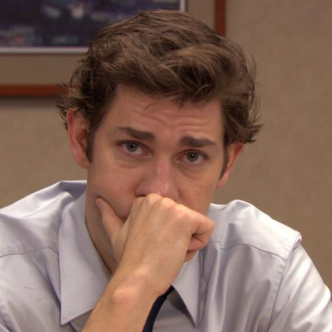 A close-up photo of Jim Parsons as Sheldon Cooper from The Big Bang Theory, resting his chin on his hand with a pensive expression.
