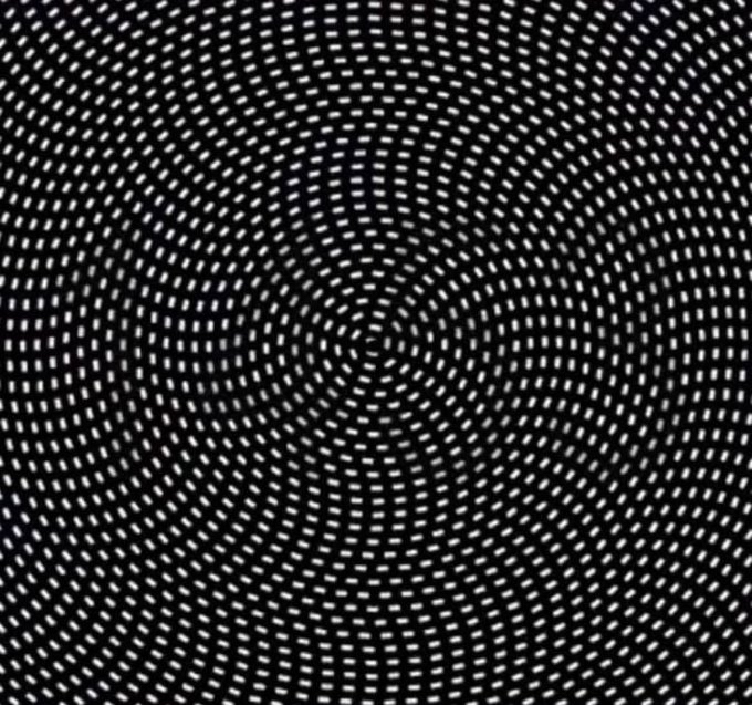 A black and white op-art pattern featuring small dashes arranged in a radiating, vortex-like design.