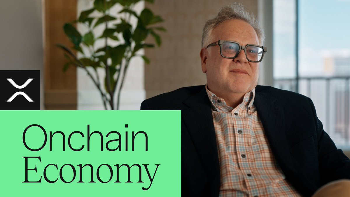 A man with glasses and a plaid shirt under a dark blazer sits in a sunlit room with a plant and city view behind him. The image is branded with the XRP logo and "Onchain Economy" title, serving as promotional artwork for an episode discussing the XRPL Foundation's role in ecosystem infrastructure.