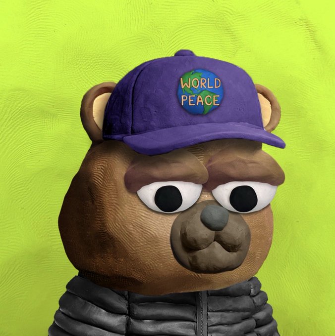A clay figurine of a brown bear wearing a black jacket and a purple cap with a 'WORLD PEACE' button featuring an Earth design, set against a green background.
