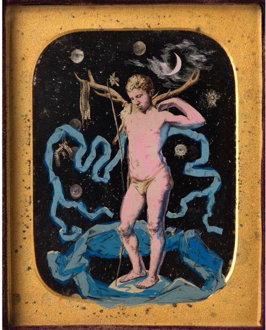 A classical-style painting depicts a nude male figure standing on rocky blue terrain against a starry night sky, holding a staff and adorned with flowing blue ribbons.