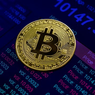 ursa coin, a gold-colored digital currency symbol, is displayed on a blue screen with white text and numbers.