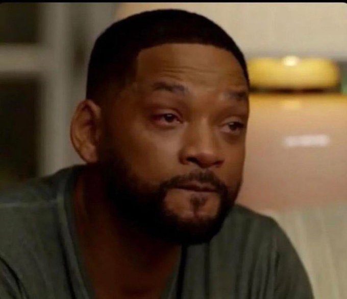 The image shows an actor with a beard, wearing a grey shirt, looking down at his hands while sitting on a couch. The actor appears to be sad or deep in thought. There are no texts or other objects visible in the image that directly relate to the question posed about the post.