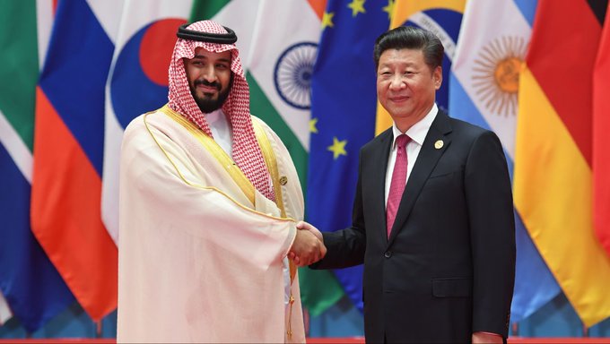 Saudi Crown Prince Mohammed bin Salman shakes hands with Chinese President Xi Jinping amidst flags of various nations, highlighting the geopolitical implications of Saudi Arabia's withdrawal from a Chinese-led digital currency initiative.