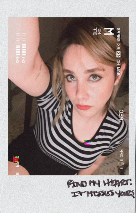 A Polaroid-style photo of a young woman in a black and white striped shirt, with handwritten text at the bottom reading "FIND MY HEART. IT MISSES yours".