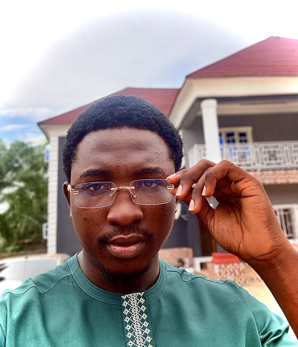 A man wearing glasses stands outside a house holding up his hand to his eye. The caption for the image says "saw a post yesterday on x saying eth had dropped sharply within an hour. i rushed to check my smol balance; nearly 30% had gone :’) you need to see the way i was just watching eth chart with optimism ;-)". This man appears to be taking a photo of his reflection in front of the house, possibly for some documentation or artistic purpose.