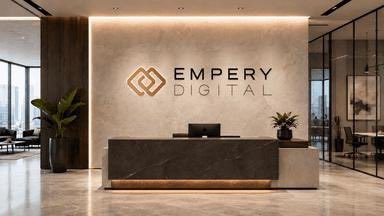 A modern office reception area with a dark desk and a wall displaying the 'EMPERY DIGITAL' logo with a geometric symbol.