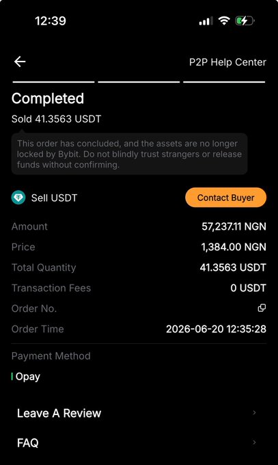 The image shows a phone screen displaying information about an order placed by someone named "IOPay" for USDT (United States Dollar). The text on the screen indicates that the transaction has been completed, and the buyer's account balance can be seen as well. The phone is turned off or in sleep mode, suggesting that it was recently used to place the order.