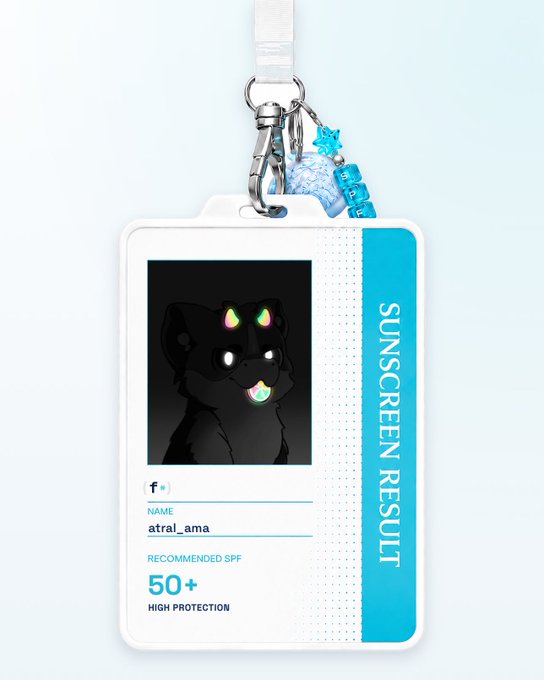 A lanyard badge featuring a black cartoon dog with rainbow horns, labeled 'SUNSCREEN RESULT' with the name 'atral_ama' and 'RECOMMENDED SPF 50+ HIGH PROTECTION'.