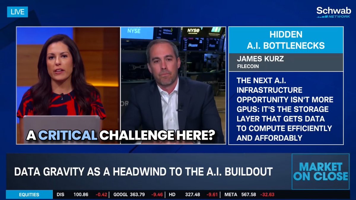 The image shows a news broadcast with two people talking about the challenges of building new GPU clusters. One person is speaking while another person listens attentively. The background features a blue screen displaying information related to the discussion, including details about data gravity and the current state of GPU clusters in various locations around the world.