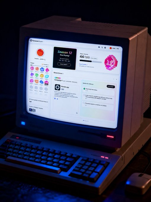 A vintage CRT computer displaying a 'Sanakan Score' web interface with 'Season 12' and 'Starlie App' panels, set in a dark environment with a keyboard and mouse.