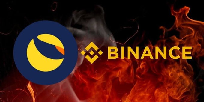 The image features the Binance logo (yellow text reading "BINANCE" with its diamond symbol) next to the Terra Classic (LUNC) emblem, set against a dramatic backdrop of fire and flames, symbolizing the burning of LUNC tokens. This visual aligns with the post about Binance's monthly LUNC burn, where 276 million coins were sent to the burn wallet on August 1st.