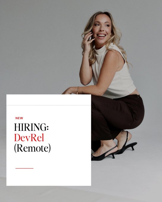 A woman in a white sleeveless top, dark pants, and black heels crouches while smiling and talking on a phone, paired with a text overlay reading "NEW HIRING: DevRel (Remote)" to advertise a remote Developer Relations position via Superteam.