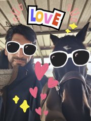 A selfie of a man and a woman on a horse with sunglasses and heart filter stickers applied, with the word 'Love' at the top.