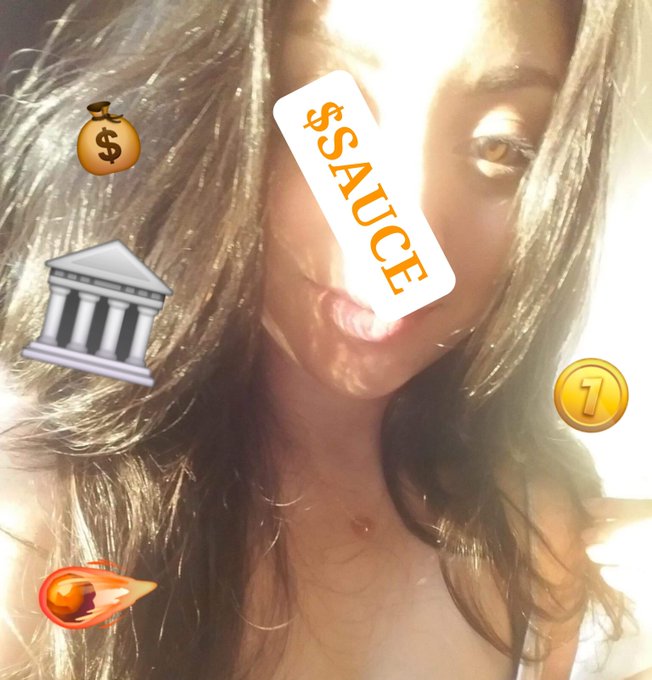 A close-up selfie of a young woman overlaid with various emojis including a money bag, bank, '$SAUCE' text, a '1' coin, and a rocket, suggesting a theme related to making money or financial success.