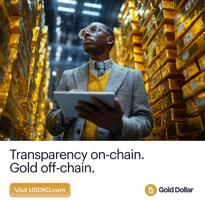 Advertisement for Gold Dollar featuring a man in a yellow sweater and gray blazer holding a tablet in a vault of gold bars, with text 'Transparency on-chain. Gold off-chain.' and 'Visit USDKG.com'.