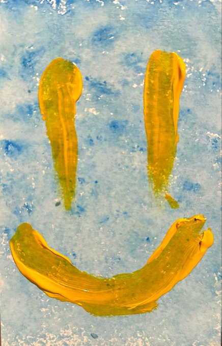 A simple smiley face painted in thick yellow strokes on a textured blue background.