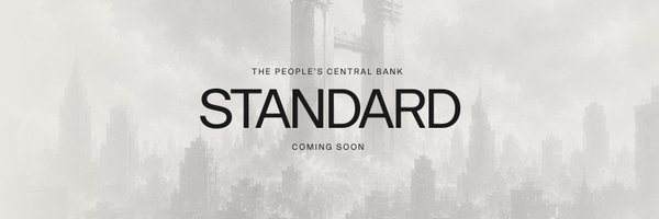 A grayscale cityscape backdrop showcases the bold text "STANDARD — THE PEOPLE'S CENTRAL BANK — COMING SOON," promoting the Standard Reserve crypto project and visually echoing the post's theme of a decentralized, code-run monetary system rising beyond traditional governance.