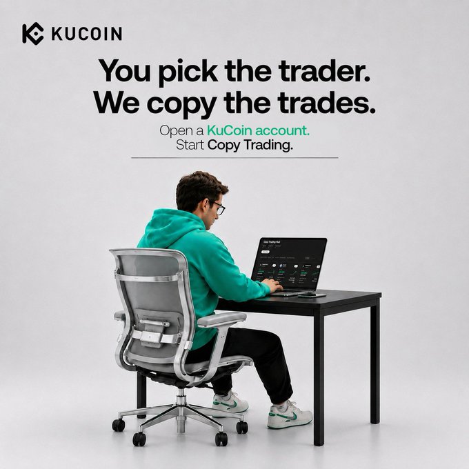 A man in a teal hoodie sits at a desk working on a laptop, with the KuCoin logo and the tagline "You pick the trader. We copy the trades. Open a KuCoin account. Start Copy Trading." displayed above him. The image visually reinforces the post's message about KuCoin Copy Trading by showing a trader actively monitoring trades, illustrating the platform's hands-off trading approach for beginners.
