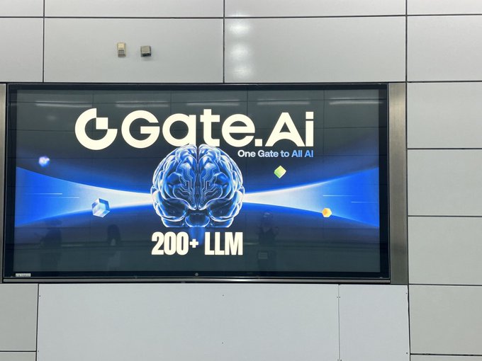 A large indoor advertising screen displaying 'GGate.Ai - One Gate to All AI' with a glowing brain graphic and '200+ LLM' text.