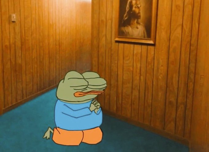 A cartoon frog character wearing a blue shirt kneels on a blue carpet in a wood-paneled room, praying with clasped hands in front of a framed picture of Jesus.